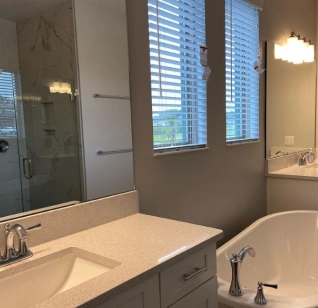 Clean bathroom with bathtub and mirror